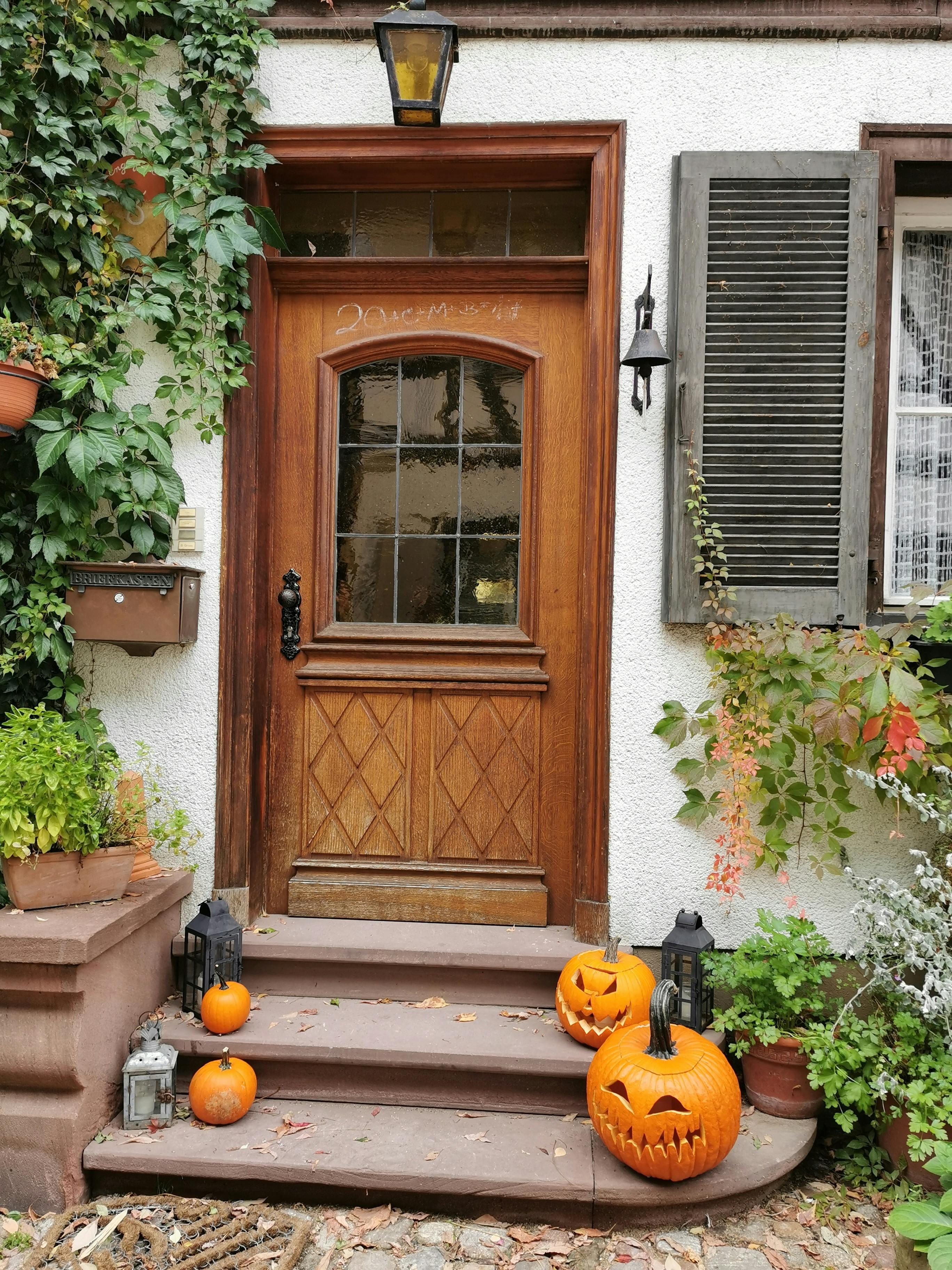 Rustic front door with Halloween decorations on the porch
